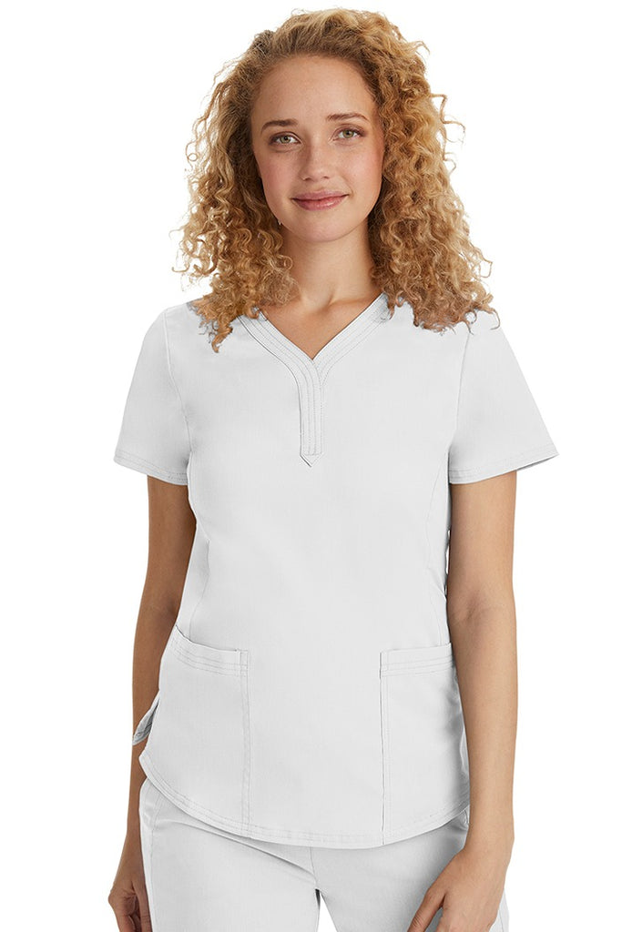 A female Emergency Room Registered Nurse wearing a Purple Label Women's Jane V-Neck Scrub Top in White featuring front seams for a flattering a fit.