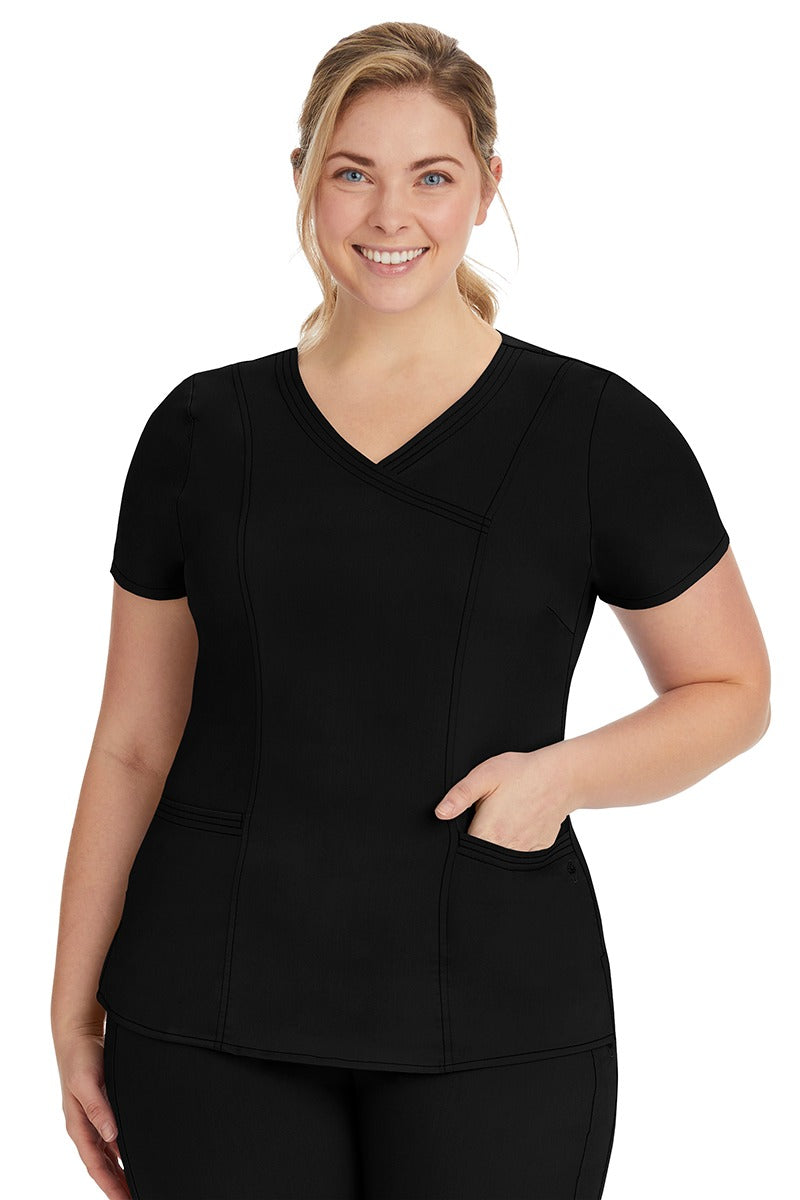 A young lady nurse wearing a Purple Label Women's Jordan Crossover Scrub Top in Black featuring a "Y" neckline.