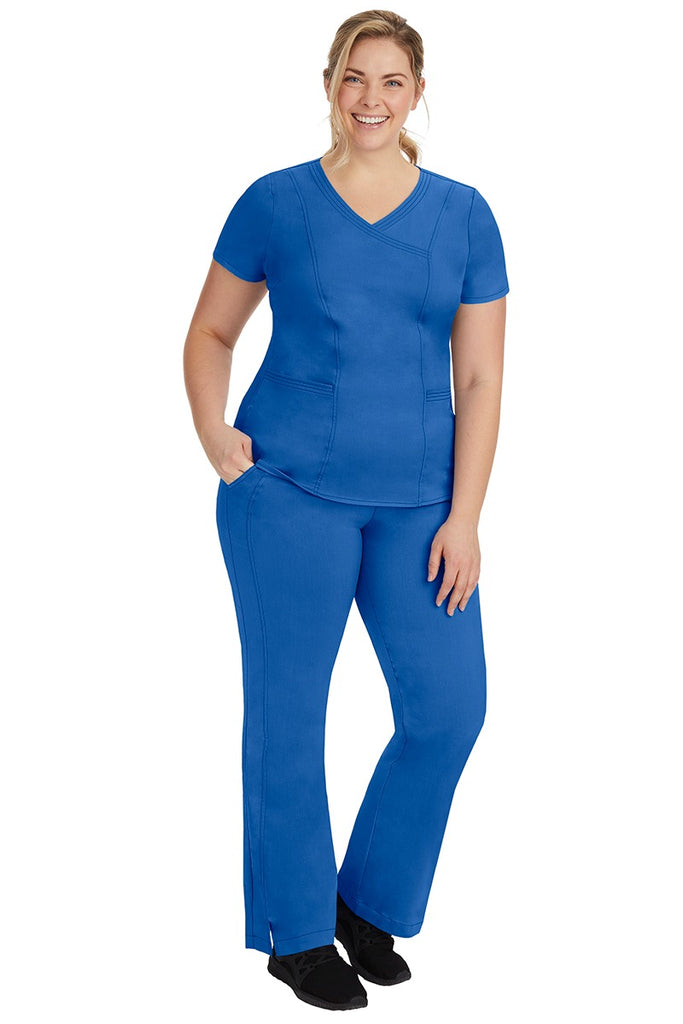 A young female nurse wearing a Women's Jordan Crossover Scrub Top from Purple Label by Healing Hands in Royal.