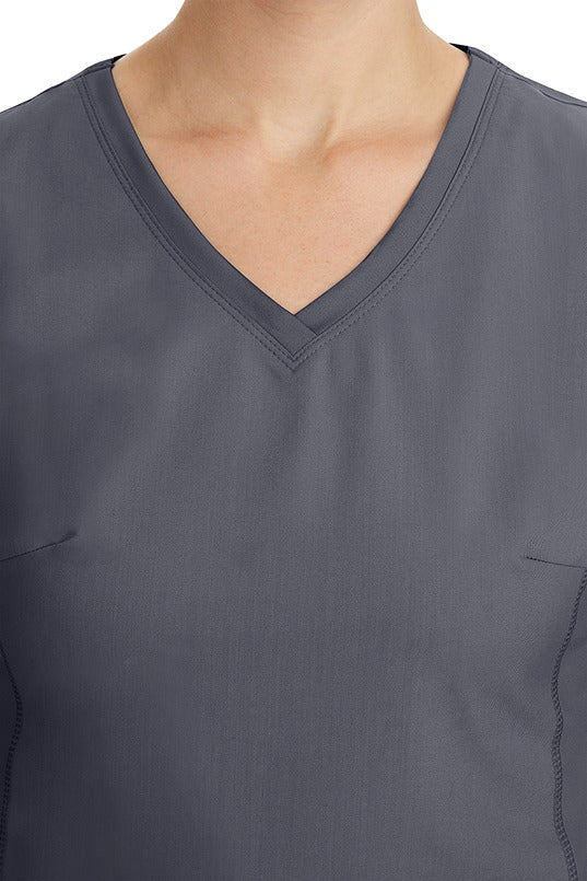 A young healthcare professional wearing a Purple Label Women's Juliet Yoga Scrub Top in Pewter featuring a modern fit.