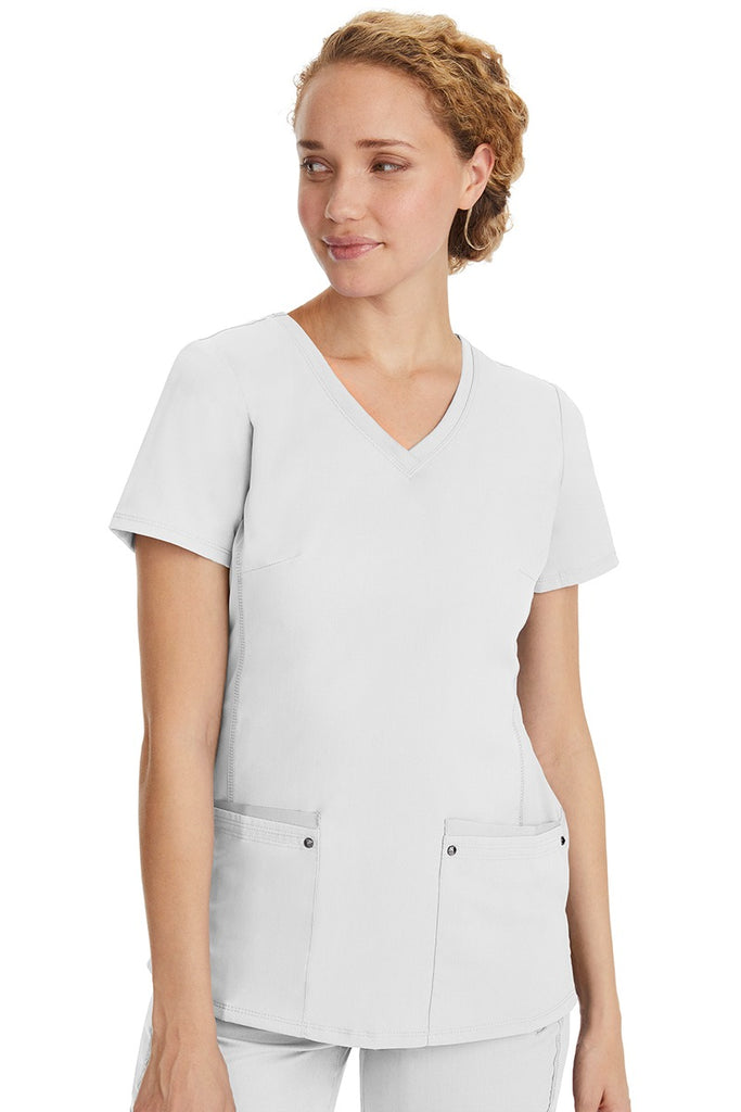 A lady nurse wearing a Purple Label Women's Juliet Yoga Scrub Top in White featuring a super comfortable stretch fabric made of 77% polyester/20% rayon/3% spandex.