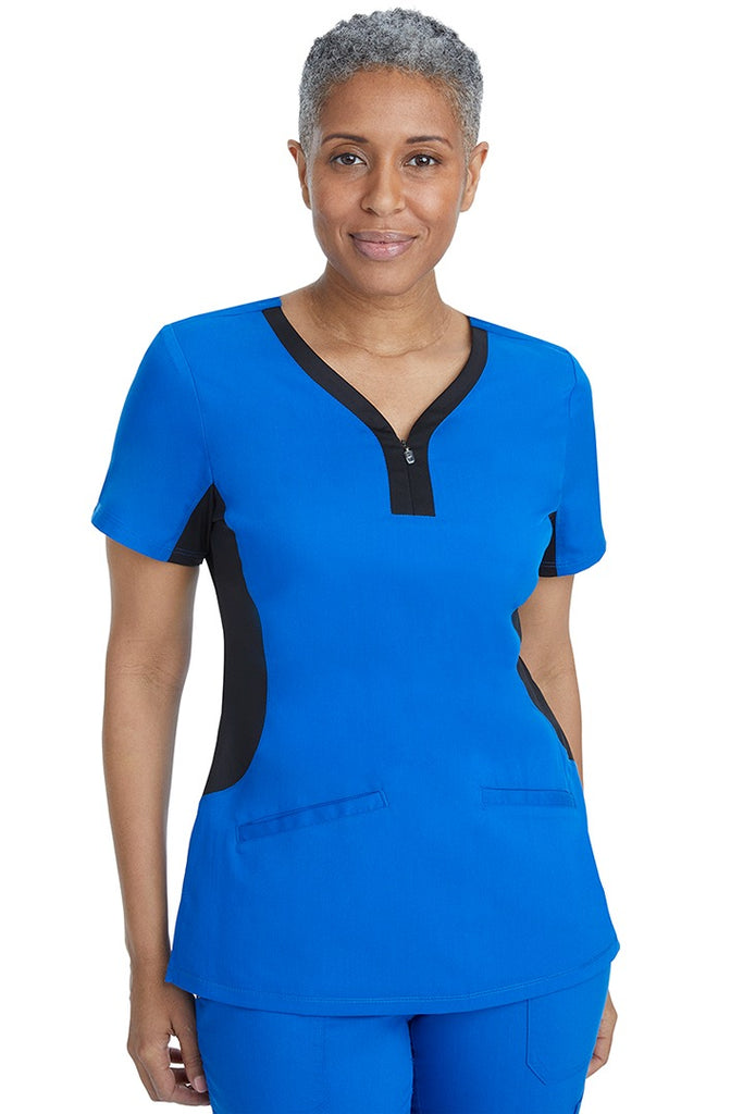 A lady nurse wearing a Women's Jessi Y-Neck Scrub Top from Purple Label by Healing Hands in Royal with Black Trim featuring a y-neckline.