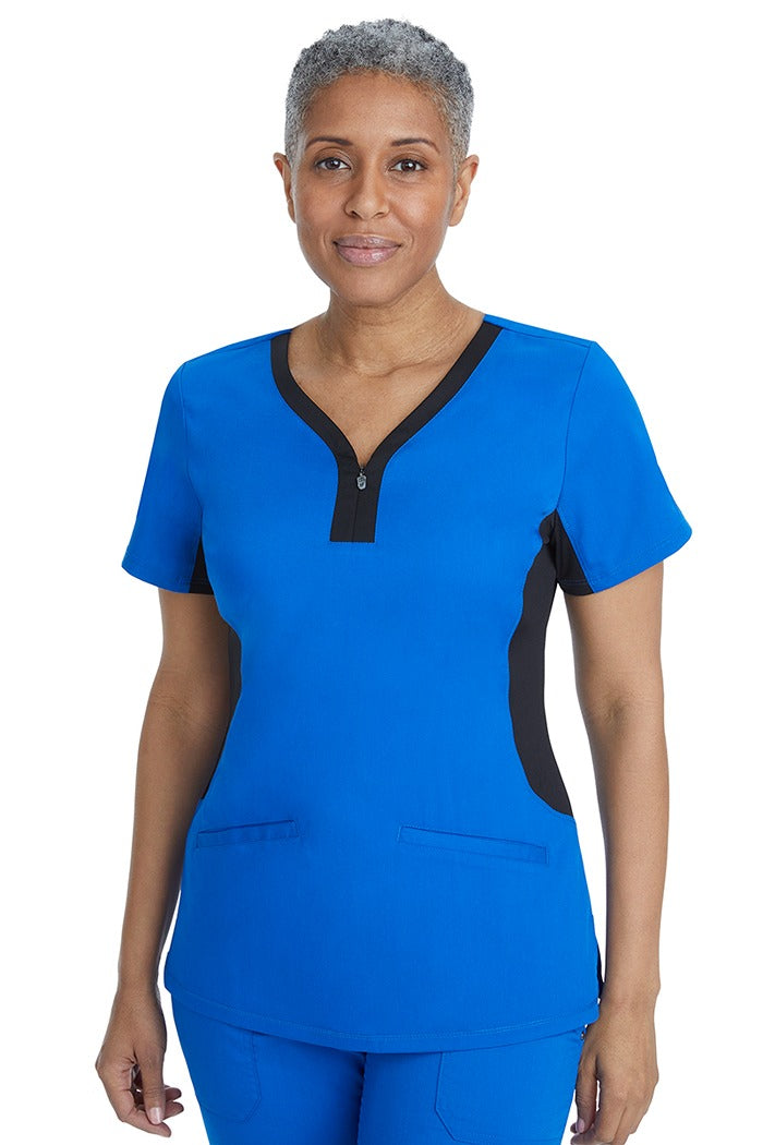 A home care registered nurse wearing a Purple Label Women's Jessi Y-Neck Scrub Top in Royal with Black Trim featuring 2 front patch pockets.