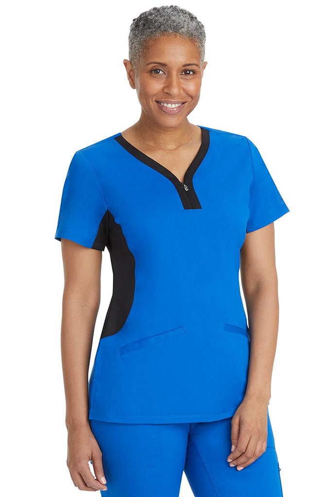 A female LPN wearing a Women's Jessi Y-Neck Scrub Top from Purple Label in Royal featuring a super comfortable stretch fabric made of 96% polyester & 4% spandex.