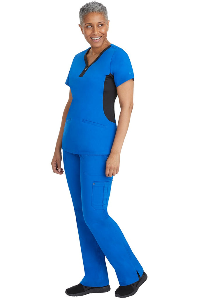 A female healthcare professional wearing a Purple Label Women's Jessi Y-Neck Scrub Top in Royal with Black Trim featuring short sleeves.