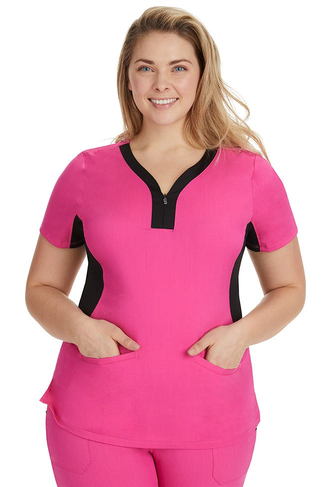 A lady nurse wearing a Women's Jessi Y-Neck Scrub Top from Purple Label by Healing Hands in Shocking Pink with Black Trim featuring a y-neckline.