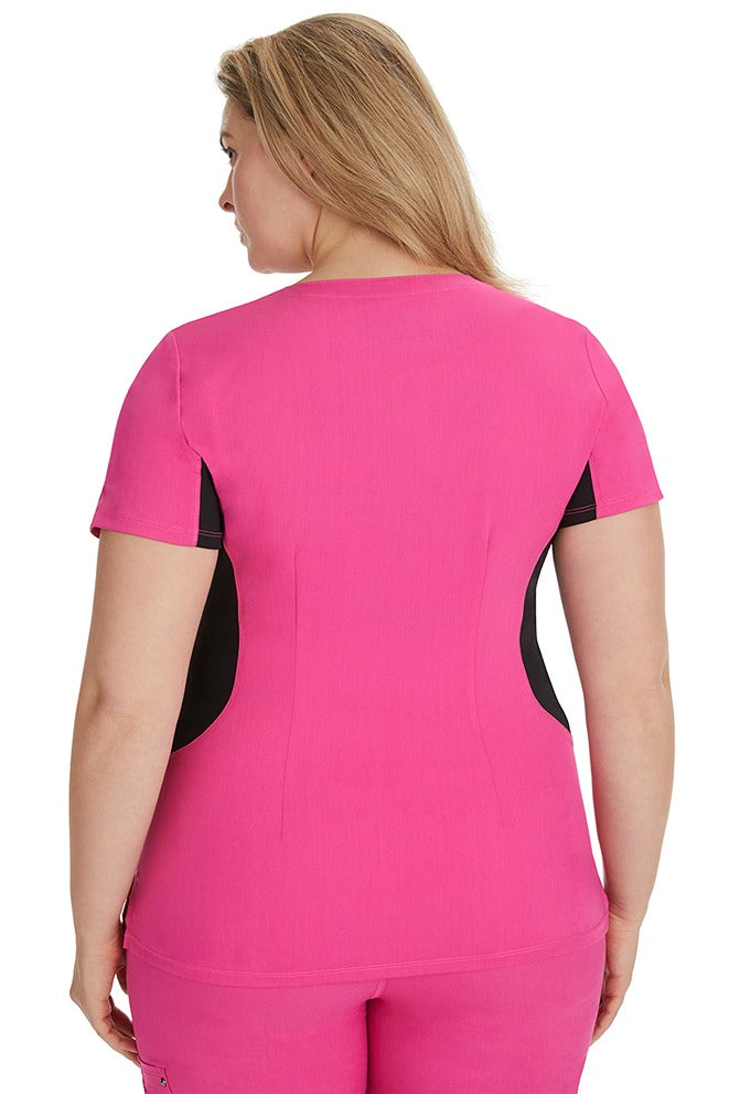 A female RN wearing a Purple Label Women's Jessi Y-Neck Scrub Top in Shocking Pink featuring a center back length of 26.5".