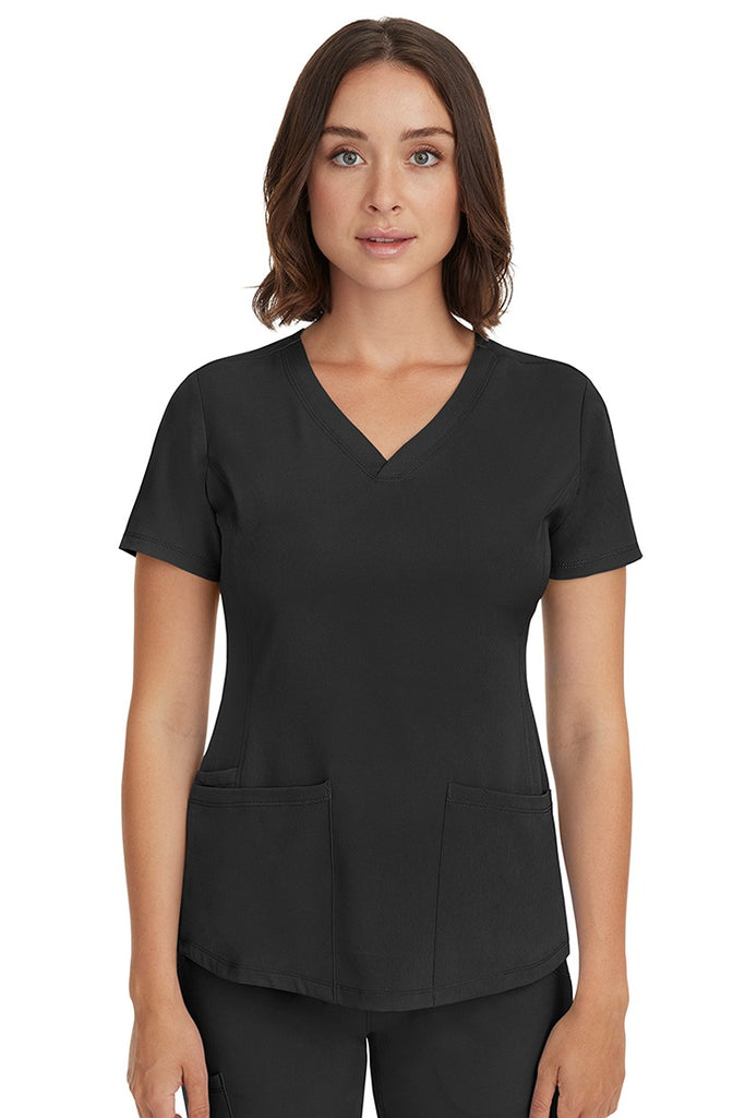 A young female LPN wearing a HH-Works Women's Monica Multi-Pocket Scrub Top in Black featuring short sleeves & a v-neckline.