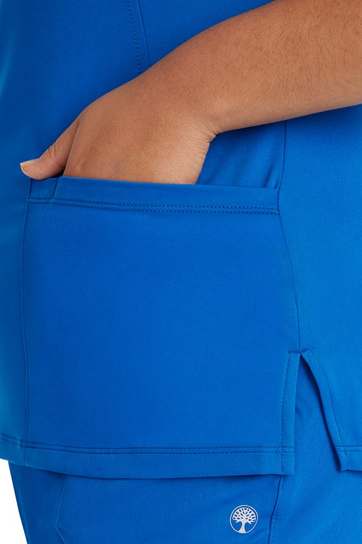 A female Nurse Practitioner wearing an HH-Works Women's Monica Multi-Pocket Scrub Top in Royal featuring a total of 4 pockets.