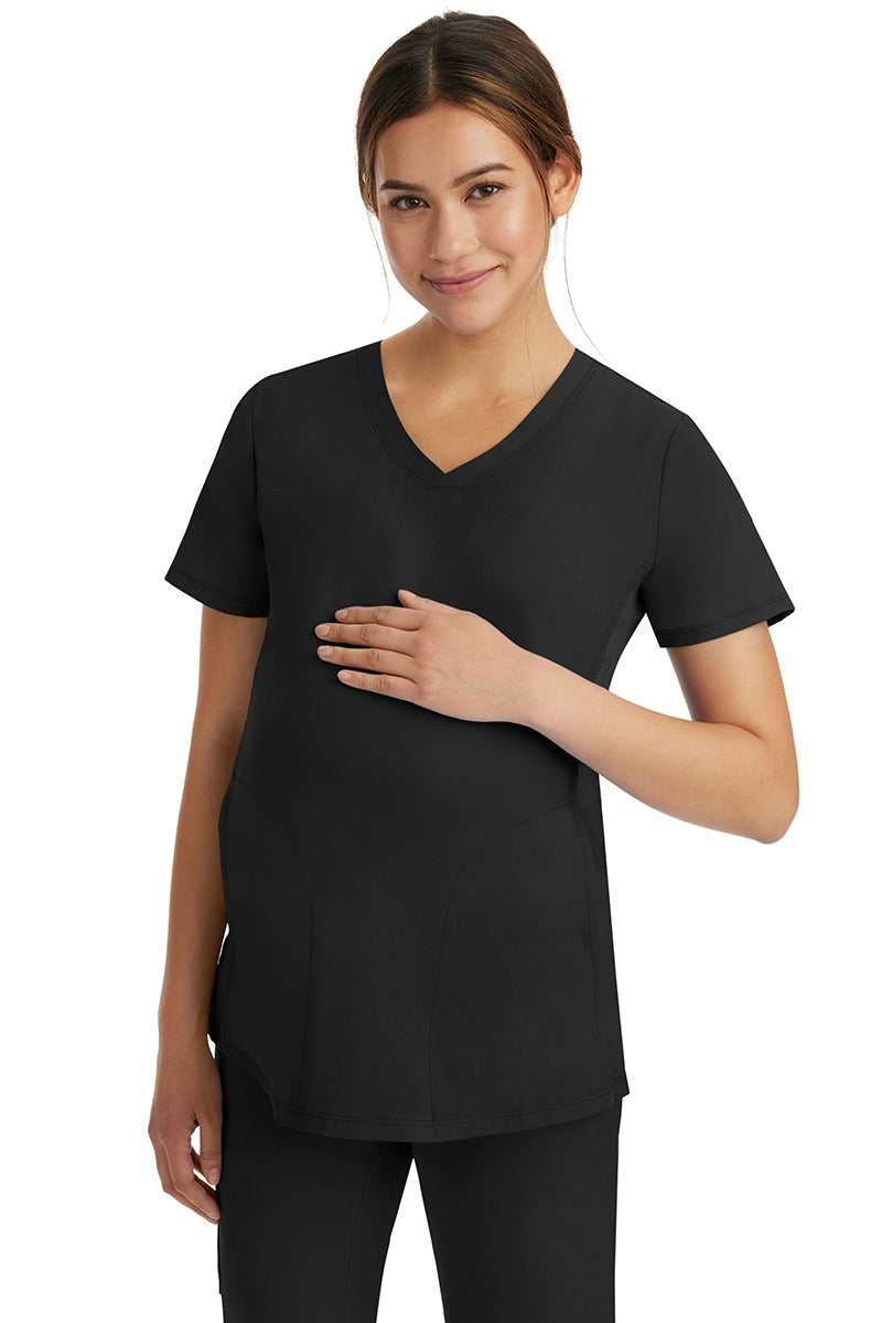 A lady Home Care Registered Nurse wearing an  HH-Works Women's Mila Maternity V-Neck Scrub Top in Black featuring a medium center back length of 27.5".
