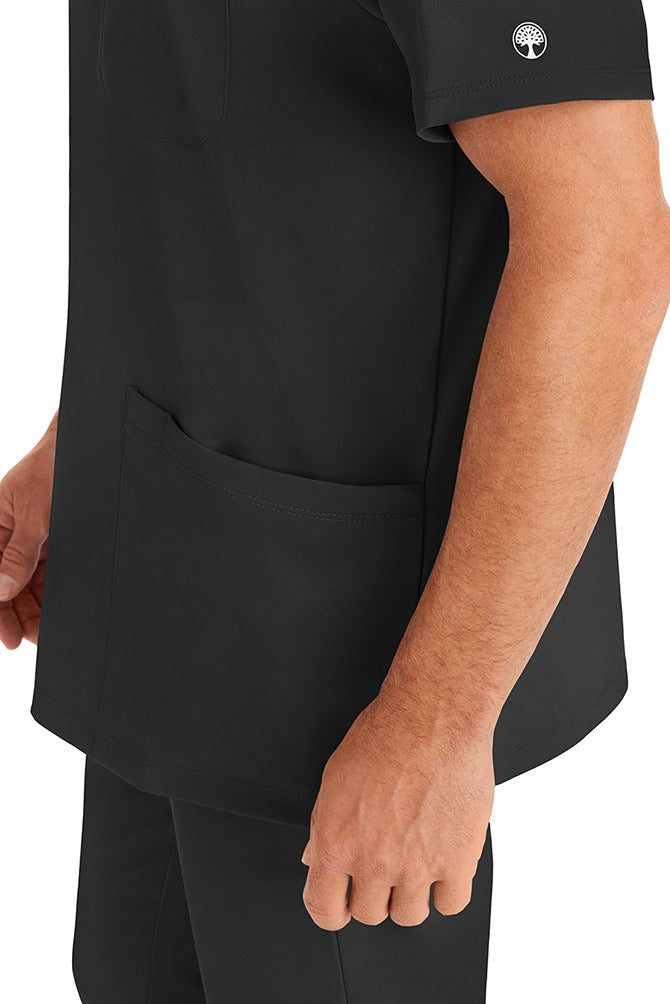 A young man wearing an HH-Works Men's Matthew V-Neck Scrub Top in Black featuring a quick drying, moisture wicking fabric. 