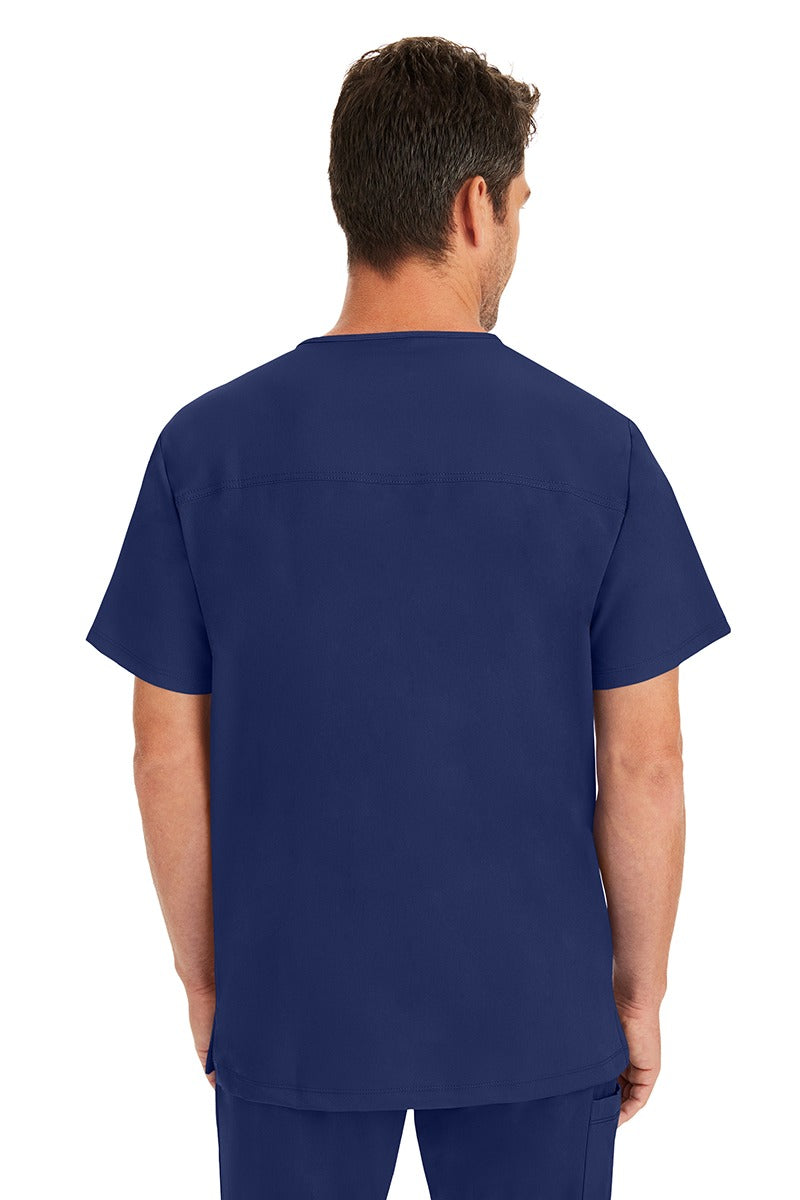 A male LPN wearing a Men's Matthew V-Neck Scrub Top from HH Works in Navy featuring a center back length of 28".