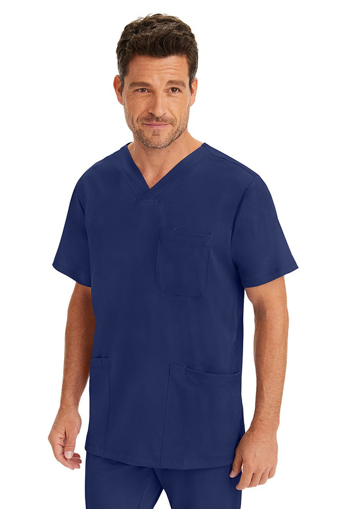 A male LVN wearing an HH-Works Men's Matthew V-Neck Scrub Top in Navy featuring a unique 4 way stretch fabric.