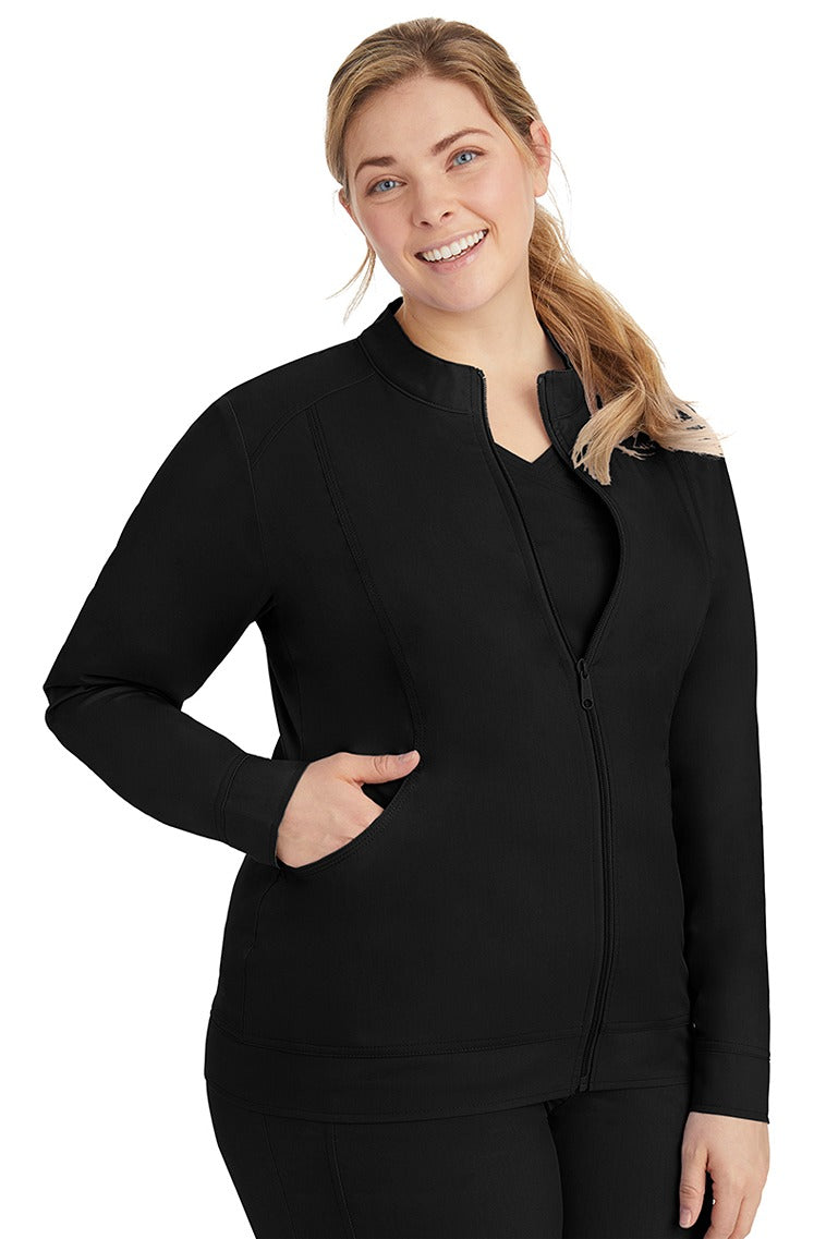 A young LPN wearing a Purple Label Women's Dakota Zip Up Scrub Jacket in Black featuring a super comfortable fabric made of 77% Polyester/20% Rayon/3% Spandex.