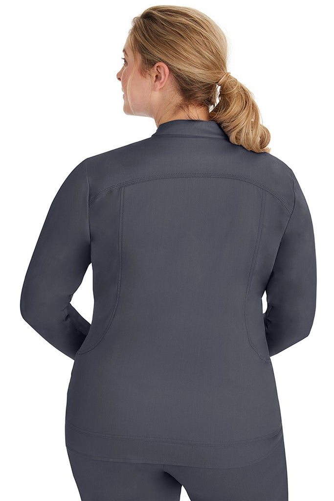 A young lady nurse wearing a Women's Dakota Zip Up Scrub Jacket from Purple Label by Healing Hands in Pewter featuring stylish seaming throughout to ensure a flattering fit.