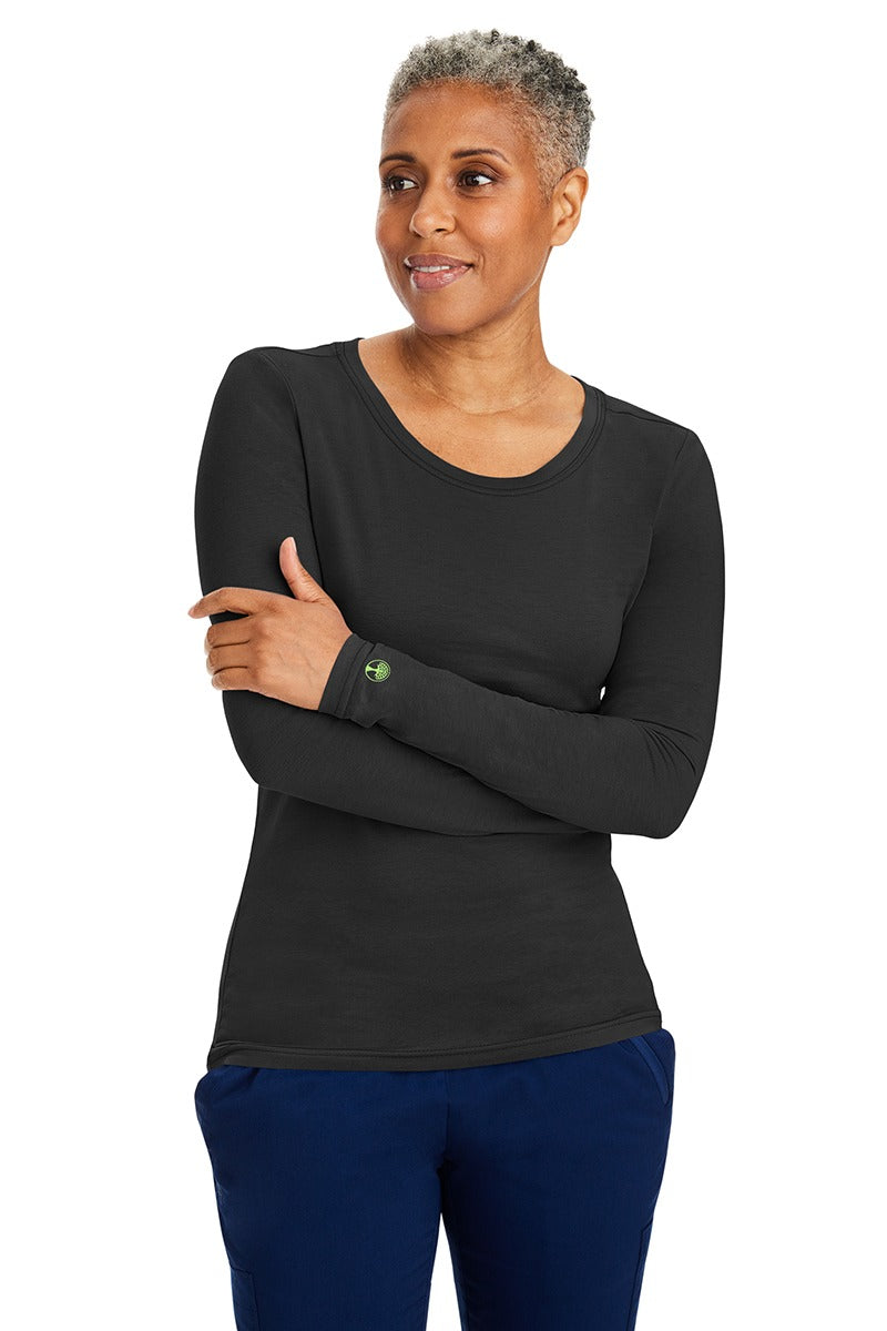 A female LPN wearing a Women's Melissa Long Sleeve T-Shirt from Purple Label by Healing Hands in Black featuring long sleeves with banded cuffs.