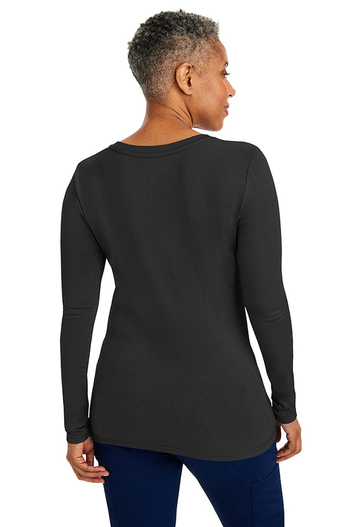 A woman Registered Nurse wearing a Purple Label Women's Melissa Long Sleeve T-Shirt in Black featuring a a superior cotton-polyester-spandex stretch fabric blend that is lightweight, soft and breathable.
