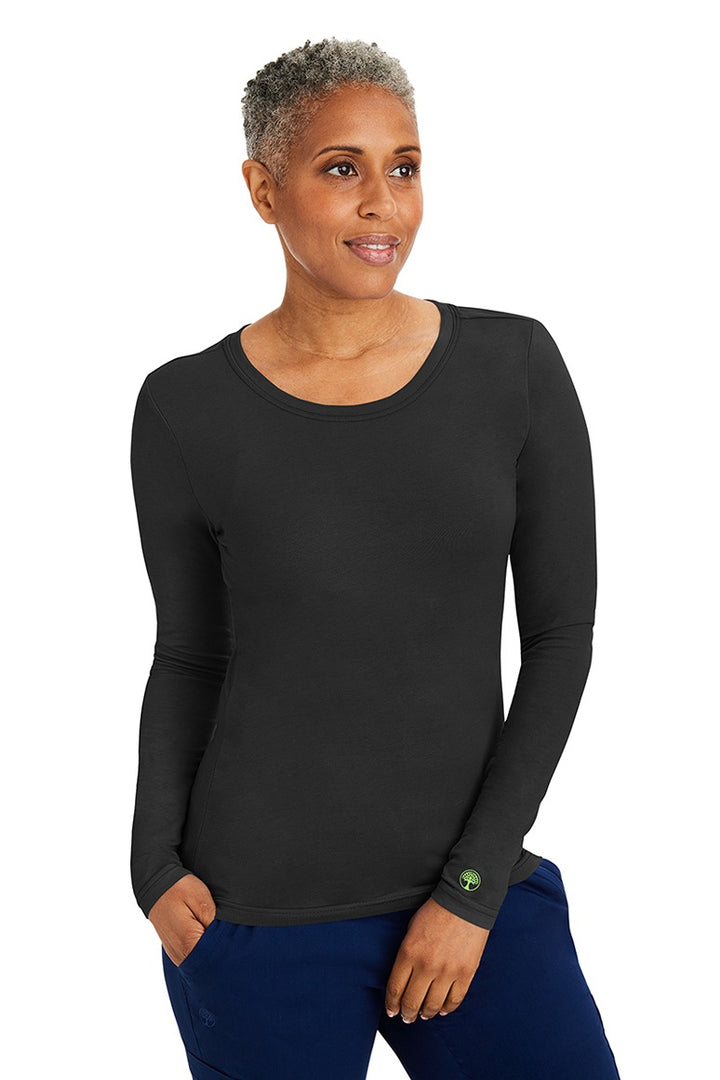 A young woman wearing a Purple Label Women's Melissa Long Sleeve T-Shirt from Healing Hands in Black featuring a modern fit & a shaped body.