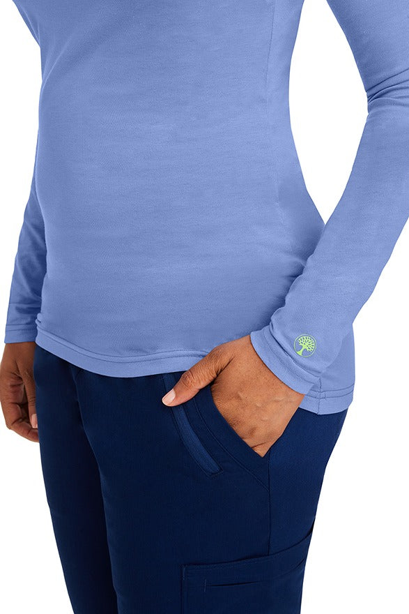A female clinical nurse specialist wearing a Purple Label Women's Melissa Long Sleeve T-Shirt in Ceil featuring a unique fabric made of 57% Cotton, 38% Polyester & 5% Spandex.