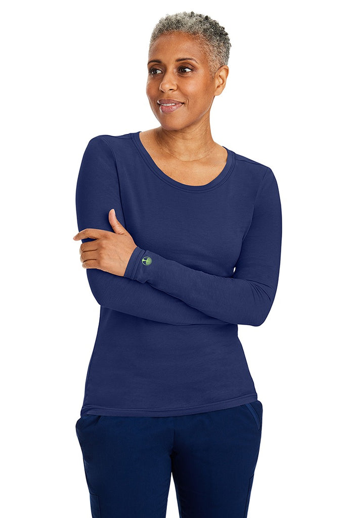 A female LPN wearing a Women's Melissa Long Sleeve T-Shirt from Purple Label by Healing Hands in Navy featuring long sleeves with banded cuffs.