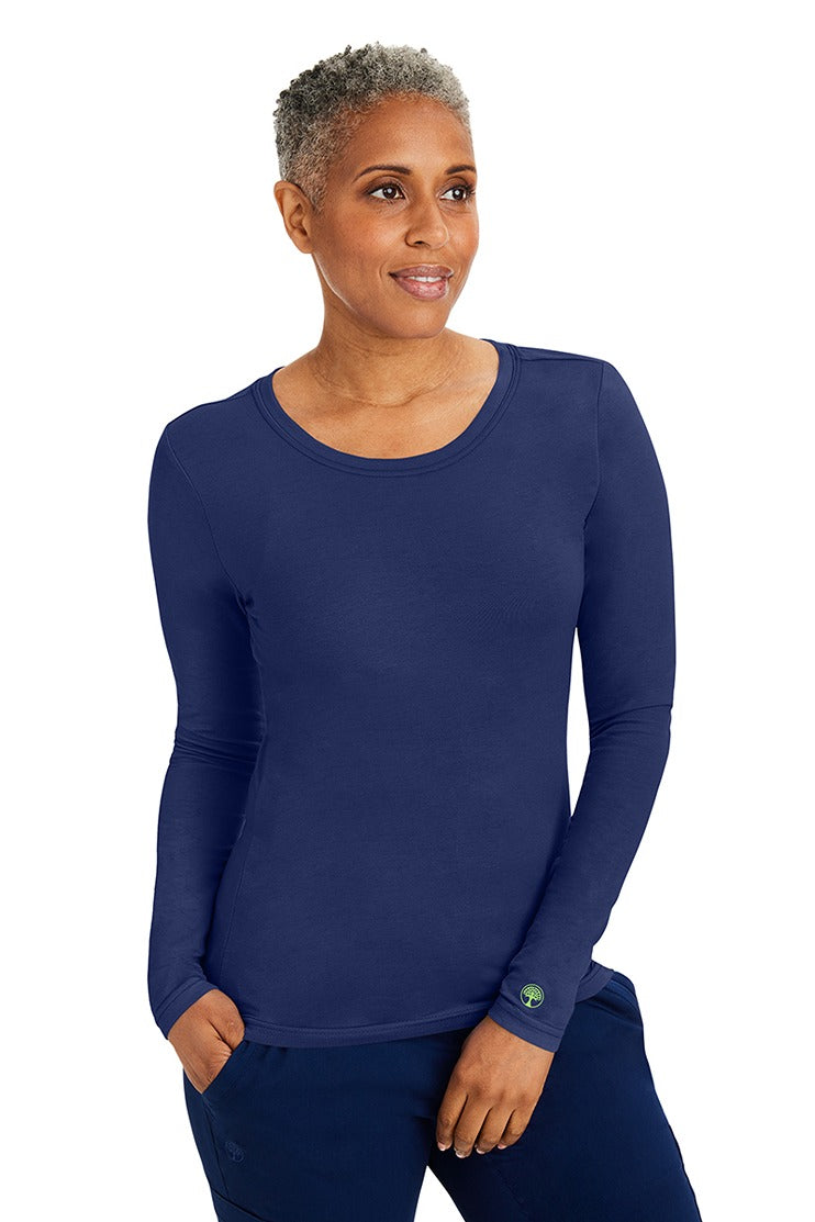 A young woman wearing a Purple Label Women's Melissa Long Sleeve T-Shirt from Healing Hands in Navy featuring a modern fit & a shaped body.