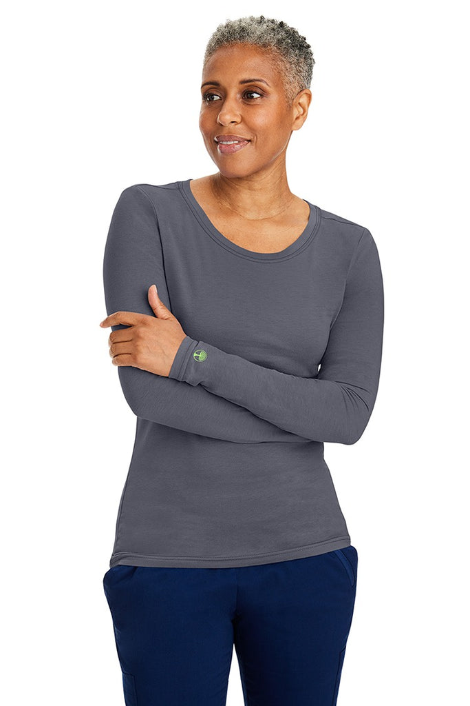 A female LPN wearing a Women's Melissa Long Sleeve T-Shirt from Purple Label by Healing Hands in Pewter featuring long sleeves with banded cuffs.