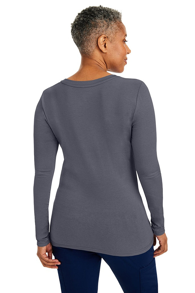 A woman Registered Nurse wearing a Purple Label Women's Melissa Long Sleeve T-Shirt in Pewter featuring a a superior cotton-polyester-spandex stretch fabric blend that is lightweight, soft and breathable.