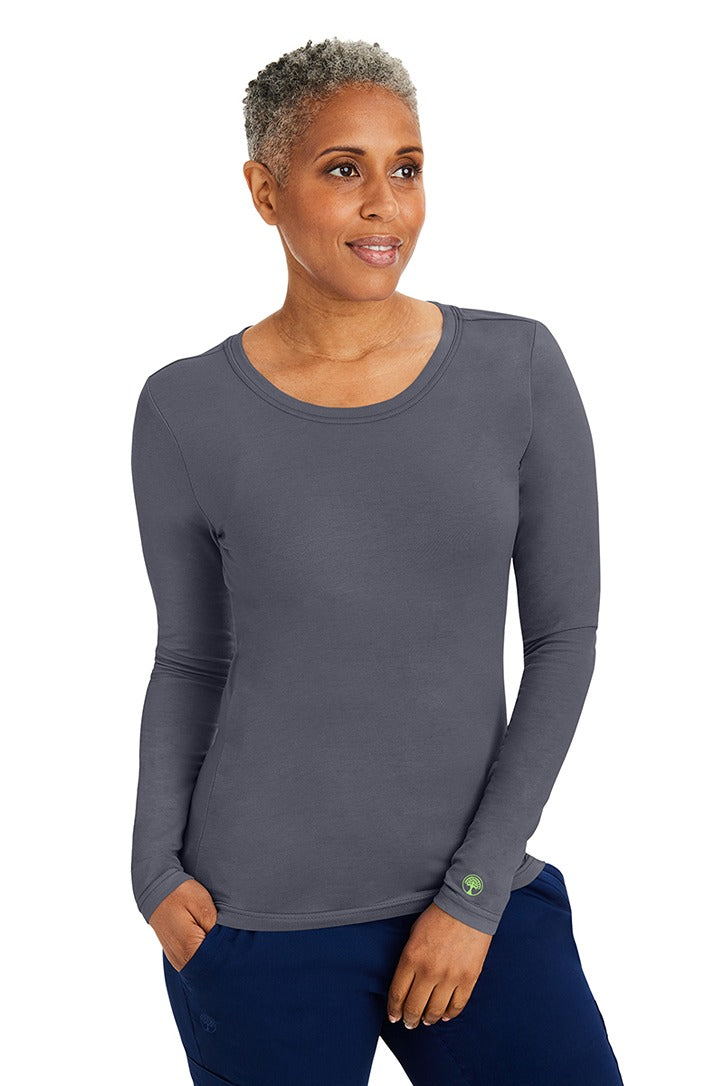 A lady CNA wearing a Purple Label Women's Melissa Long Sleeve T-Shirt in Pewter featuring a slim fit to provide a flattering all day look.