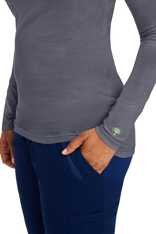 A female clinical nurse specialist wearing a Purple Label Women's Melissa Long Sleeve T-Shirt in Pewter featuring a unique fabric made of 57% Cotton, 38% Polyester & 5% Spandex.