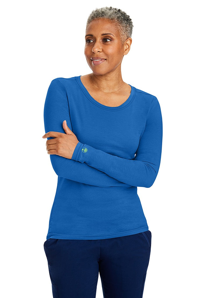 A female LPN wearing a Women's Melissa Long Sleeve T-Shirt from Purple Label by Healing Hands in Royal featuring long sleeves with banded cuffs.