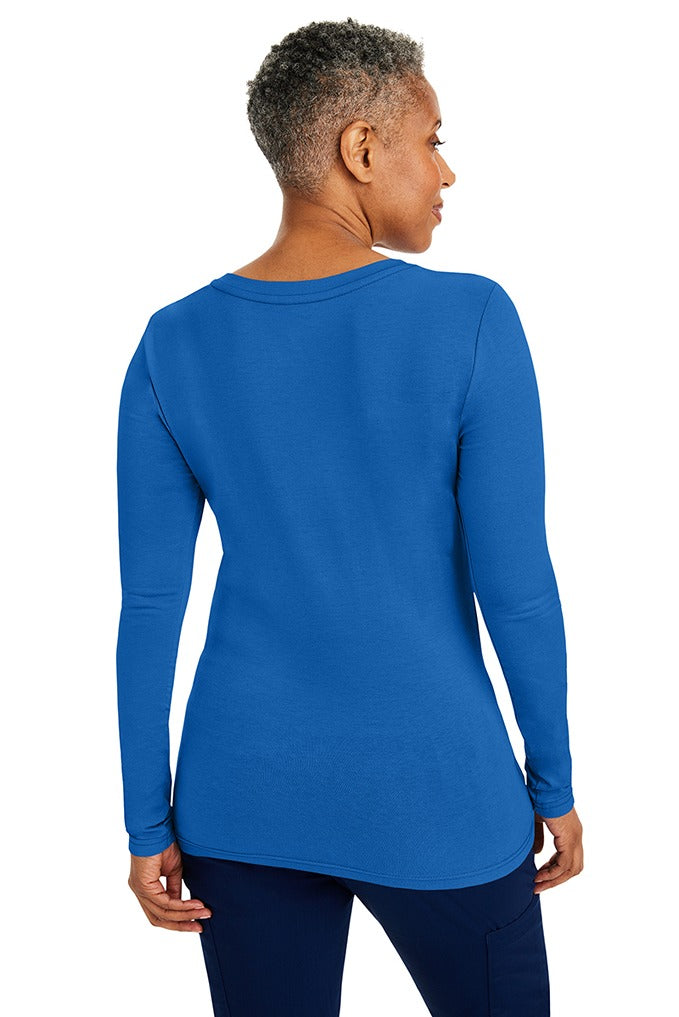 A woman Registered Nurse wearing a Purple Label Women's Melissa Long Sleeve T-Shirt in Royal featuring a a superior cotton-polyester-spandex stretch fabric blend that is lightweight, soft and breathable.