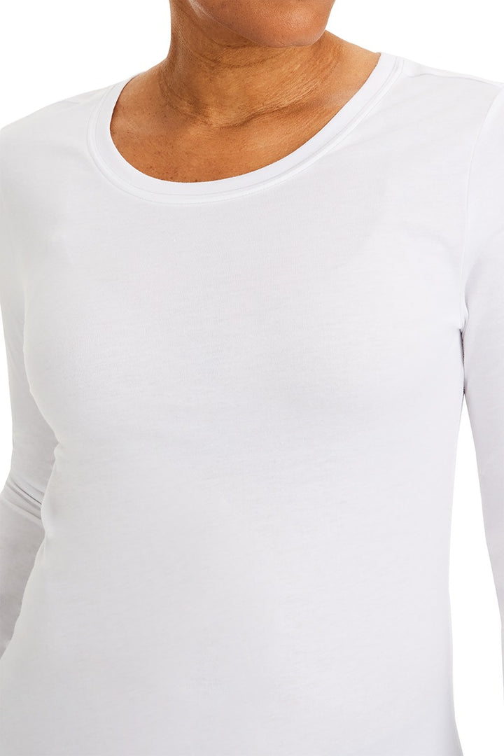 A young woman wearing a Purple Label Women's Melissa Long Sleeve T-Shirt from Healing Hands in White featuring a modern fit & a shaped body.