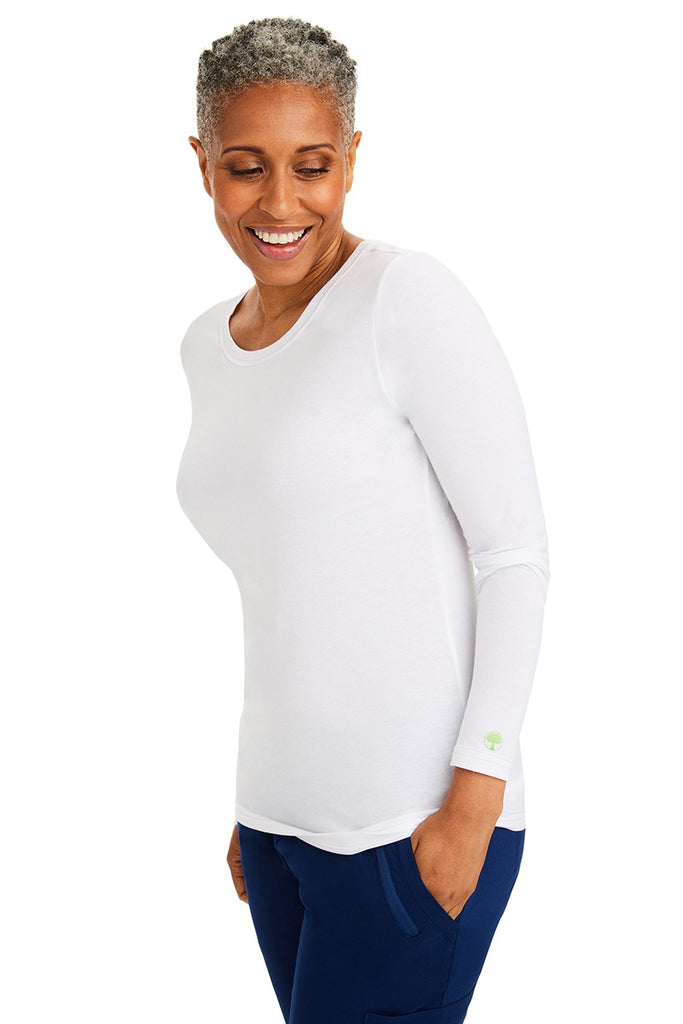 A female LPN wearing a Women's Melissa Long Sleeve T-Shirt from Purple Label by Healing Hands in White featuring long sleeves with banded cuffs.