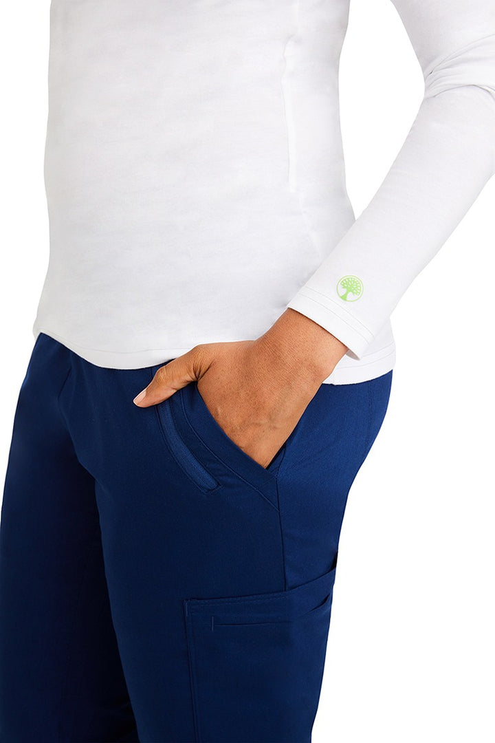 A female clinical nurse specialist wearing a Purple Label Women's Melissa Long Sleeve T-Shirt in White featuring a unique fabric made of 57% Cotton, 38% Polyester & 5% Spandex.