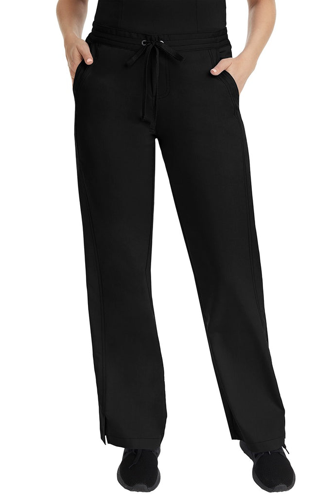 A female LPN wearing a pair of Purple Label Women's Taylor Drawstring Scrub Pants from Healing Hands in Black featuring a front drawstring waist.