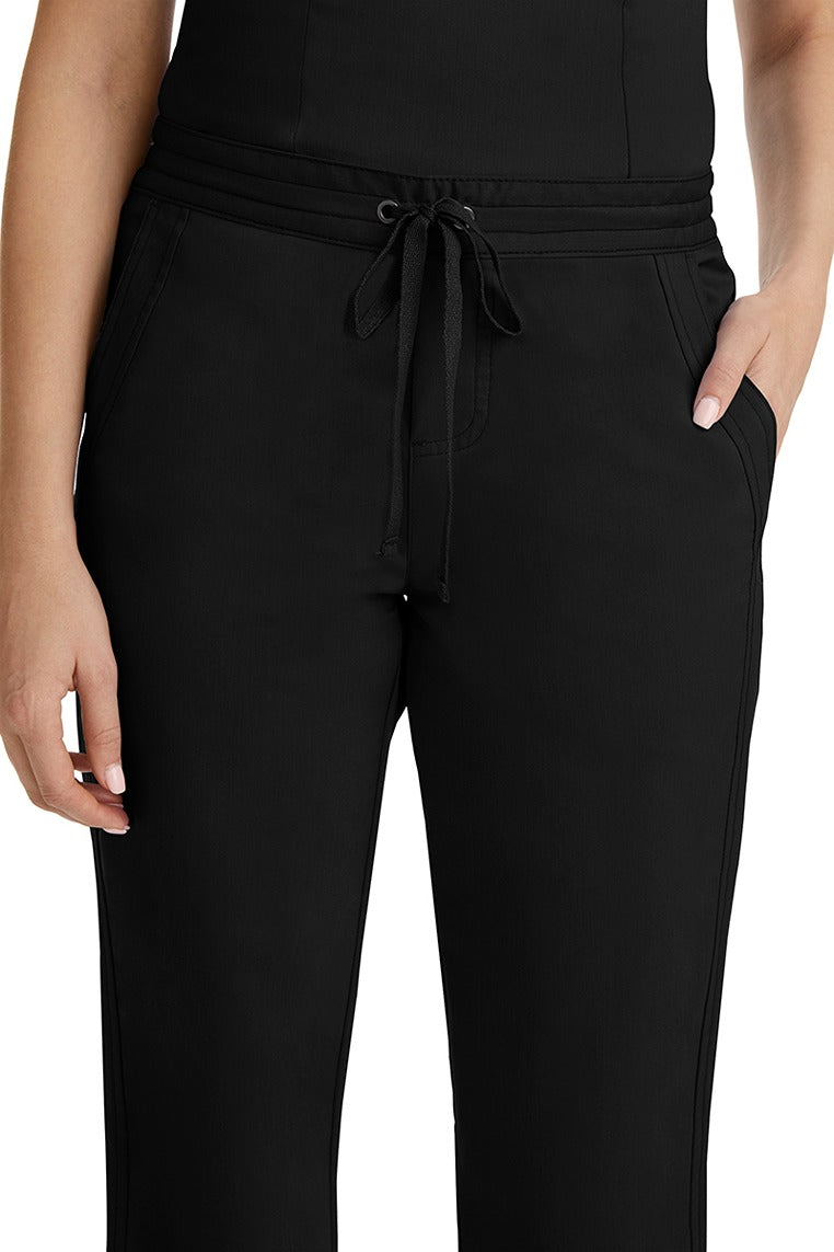 A female healthcare professional wearing a Purple Label Women's Taylor Drawstring Scrub Pant in Black featuring triple needle stitching throughout.