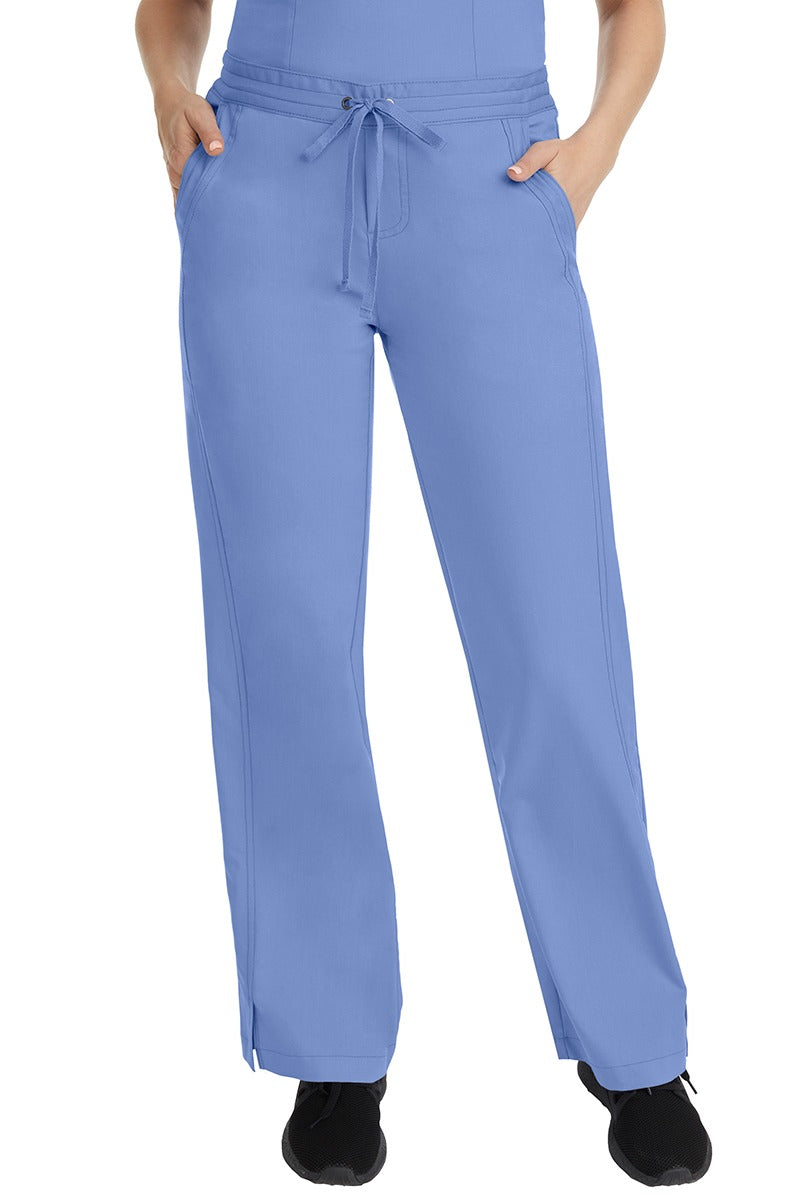 A female LPN wearing a pair of Purple Label Women's Taylor Drawstring Scrub Pants from Healing Hands in Ceilfeaturing a front drawstring waist.