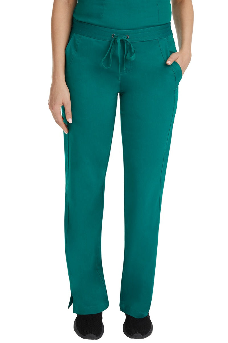 A female LPN wearing a pair of Purple Label Women's Taylor Drawstring Scrub Pants from Healing Hands in Hunter Green featuring a front drawstring waist.
