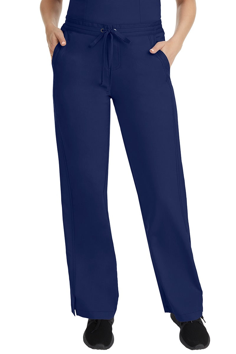 A female LPN wearing a pair of Purple Label Women's Taylor Drawstring Scrub Pants from Healing Hands in Navy featuring a front drawstring waist.