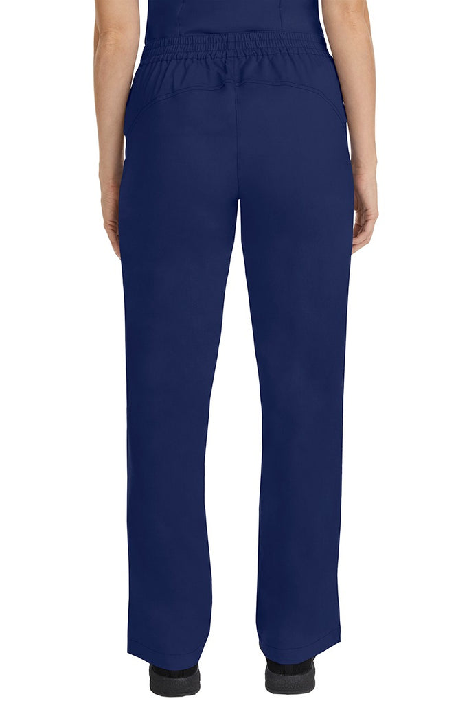 A female CNA wearing a pair of Purple Label Women's Taylor Drawstring Scrub Pants in Navy featuring a back yoke to ensure comfortable & flattering all day fit.