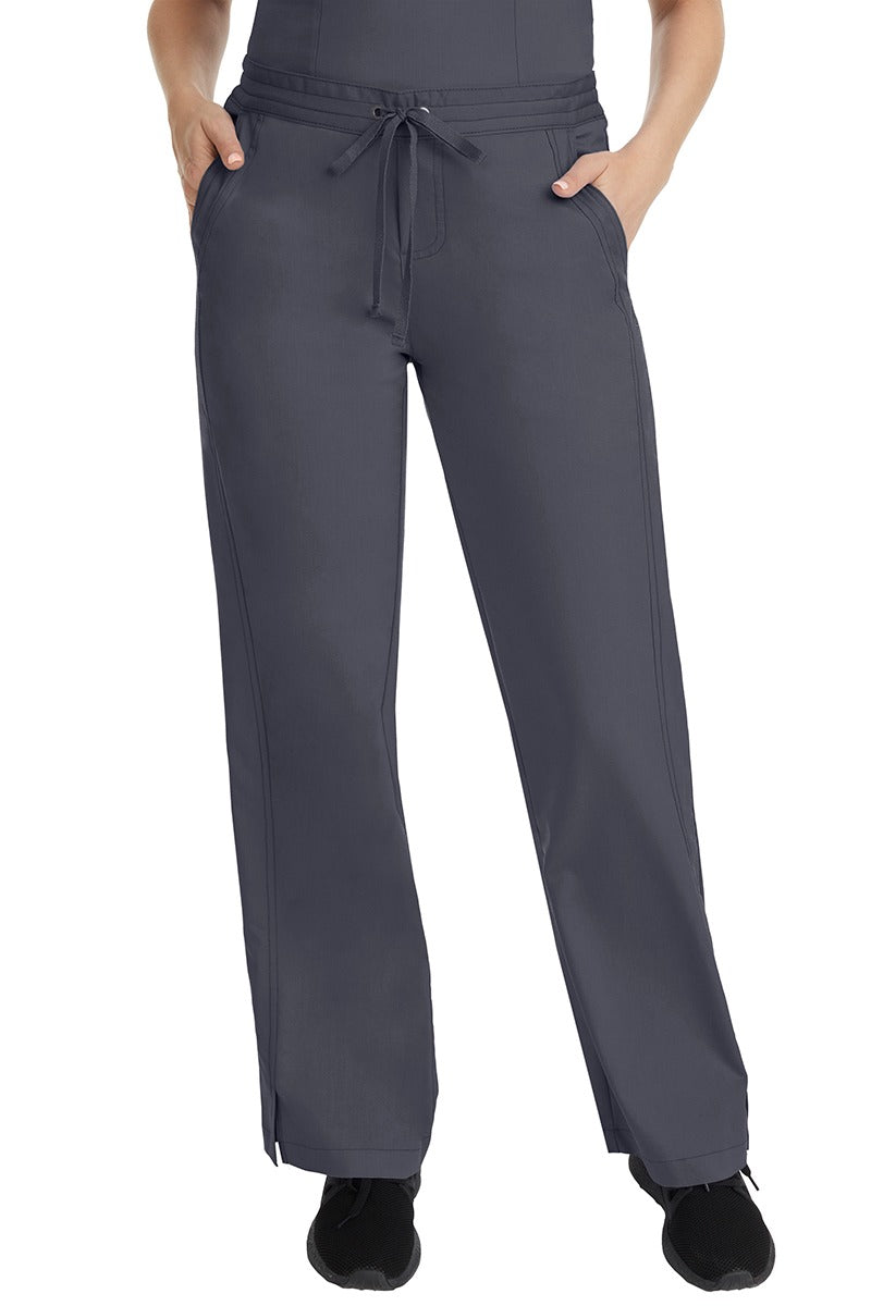 A female LPN wearing a pair of Purple Label Women's Taylor Drawstring Scrub Pants from Healing Hands in Pewter featuring a front drawstring waist.