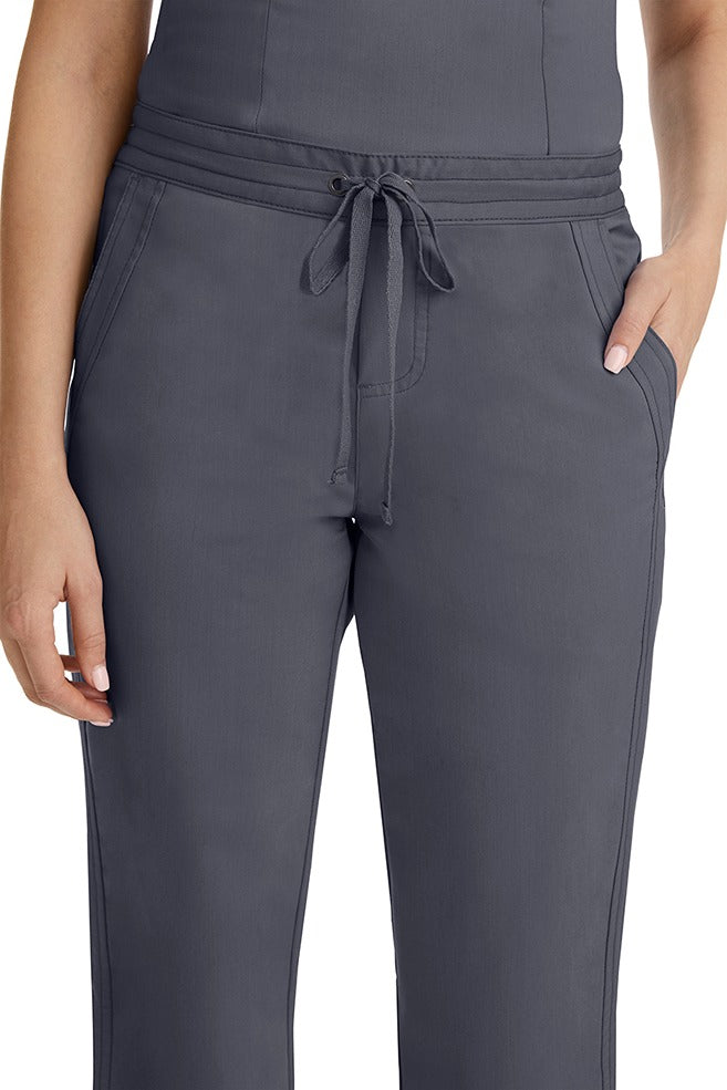 A female healthcare professional wearing a Purple Label Women's Taylor Drawstring Scrub Pant in Pewter featuring triple needle stitching throughout.