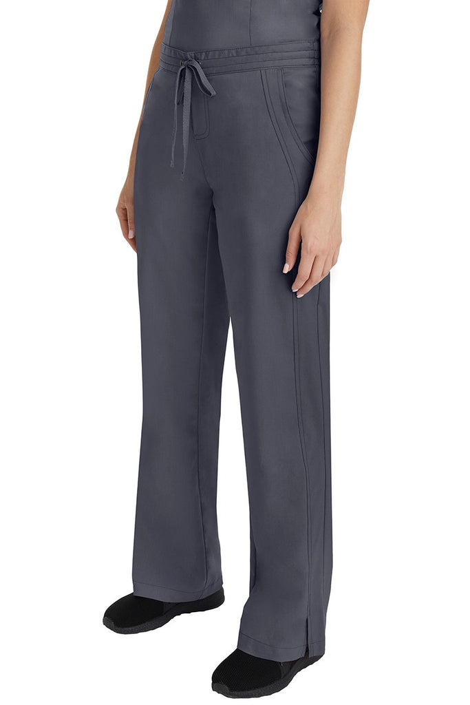 A young Home Care Registered Nurse wearing a Purple Label Women's Taylor Drawstring Scrub Pant in Pewter featuring front wrap seaming detail throughout.