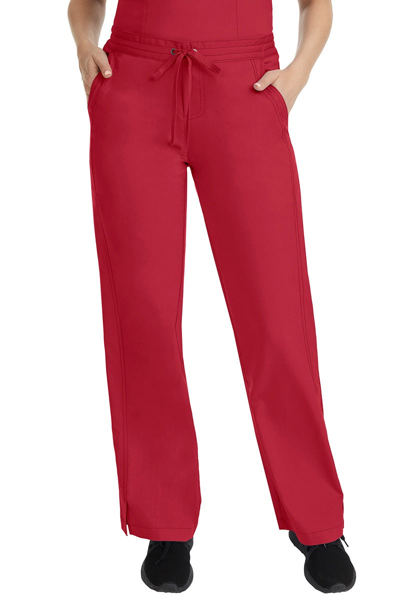 A female LPN wearing a pair of Purple Label Women's Taylor Drawstring Scrub Pants from Healing Hands in Red featuring a front drawstring waist.