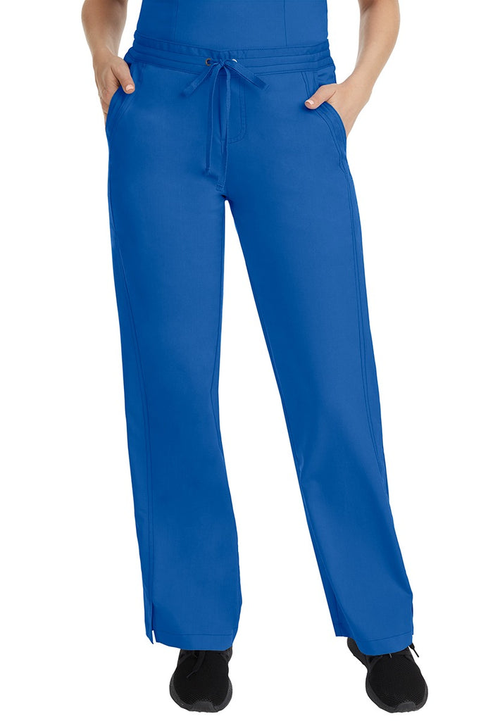 A female LPN wearing a pair of Purple Label Women's Taylor Drawstring Scrub Pants from Healing Hands in Royal featuring a front drawstring waist.
