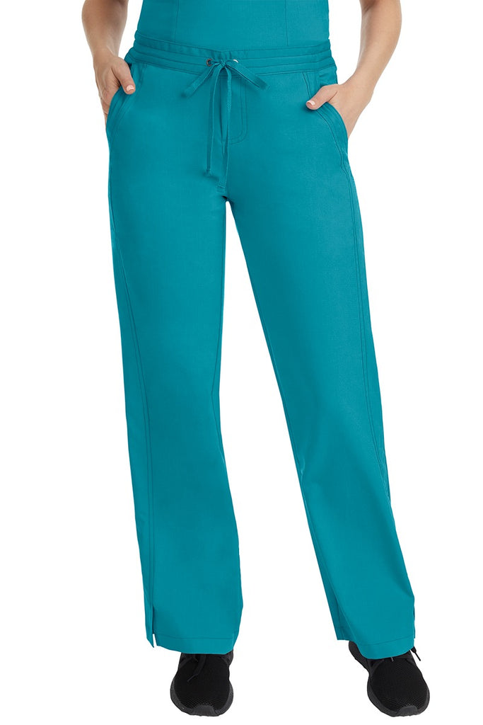 A female LPN wearing a pair of Purple Label Women's Taylor Drawstring Scrub Pants from Healing Hands in Teal featuring a front drawstring waist.