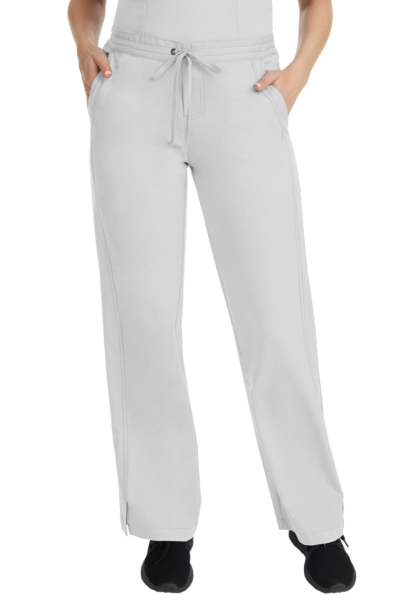 A female LPN wearing a pair of Purple Label Women's Taylor Drawstring Scrub Pants from Healing Hands in White featuring a front drawstring waist.