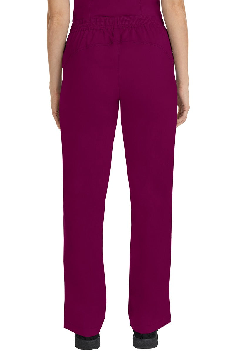 A female CNA wearing a pair of Purple Label Women's Taylor Drawstring Scrub Pants in Wine featuring a back yoke to ensure comfortable & flattering all day fit.