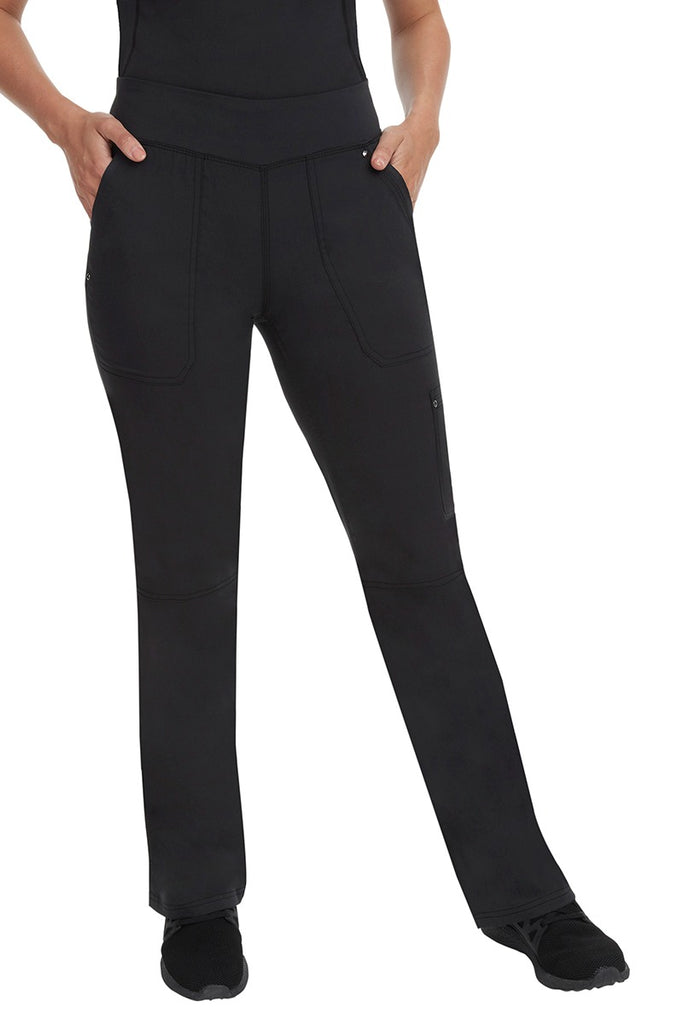 A young woman wearing a Purple Label Women's Tori Yoga Waistband Scrub Pant in Black featuring a yoga knit waistband.