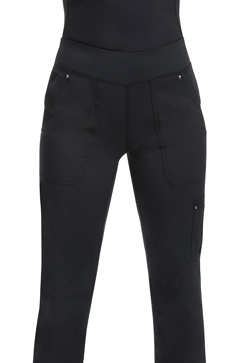 A young woman wearing a pair of Purple Label Women's Tori Yoga Waistband Scrub Pants in Black featuring a fabric made of  77% Polyester/ 20% Rayon/ 3% Spandex.